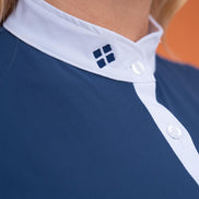 Close-up of a blue shirt with white trim and a logo on an orange background