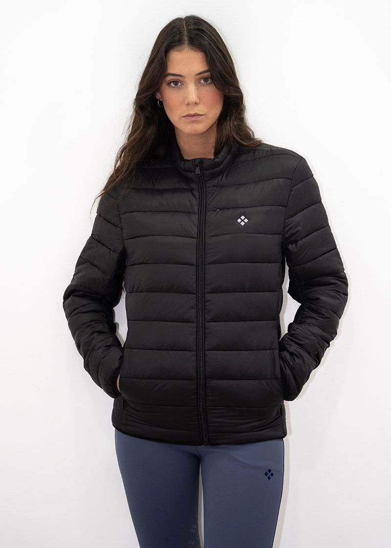 Woman wearing a black puffer jacket on a white background