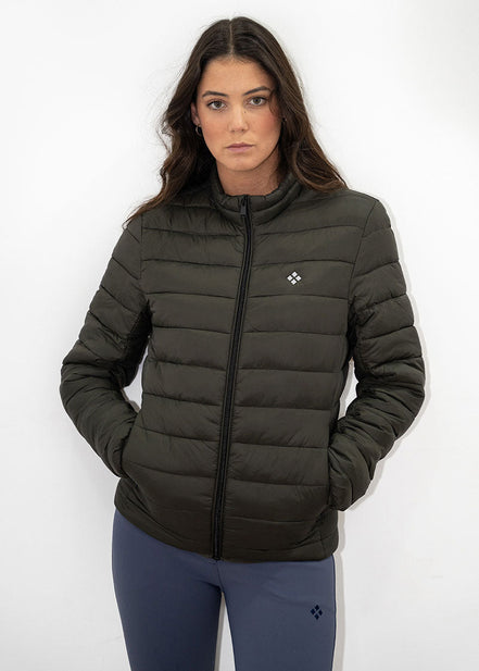 Woman wearing a dark green puffer jacket with a logo on a white background