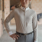 Woman wearing a light gray shirt and gray pants in an indoor setting