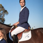 Man riding a horse with a clear blue sky in the background