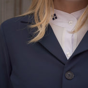 Person wearing a navy blazer over a white shirt with visible buttons.